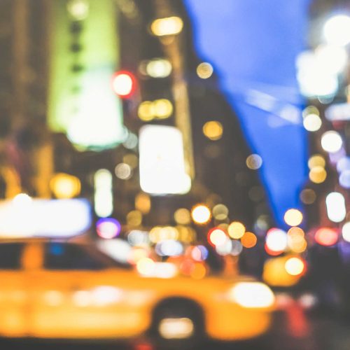 blurry image of a taxi in the city